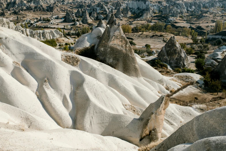 a large rock formation in the middle of a desert, a marble sculpture, trending on unsplash, art nouveau, istanbul, lots of white cotton, joel sternfeld, panoramic