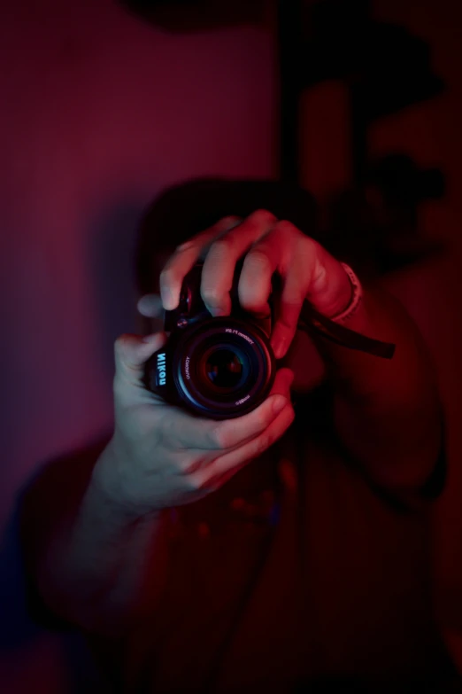 a person taking a picture with a camera, inspired by Elsa Bleda, red and blue black light, ((sharp focus)), profile picture 1024px, low quality photo