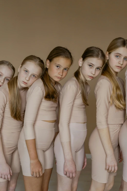 a group of young women standing next to each other, inspired by Vanessa Beecroft, trending on pexels, hyperrealism, children, leotard, sad look, 15081959 21121991 01012000 4k