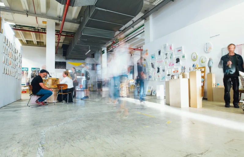 a group of people sitting around a table in a room, pexels contest winner, process art, in a open-space working space, walking to the right, ultrastation hq, chemical woekshop