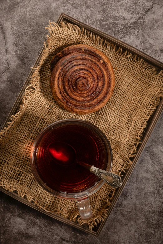 a cup of tea and a pastry on a tray, by Edward Avedisian, hurufiyya, oganic rippling spirals, dark red, 4l, cinnamon