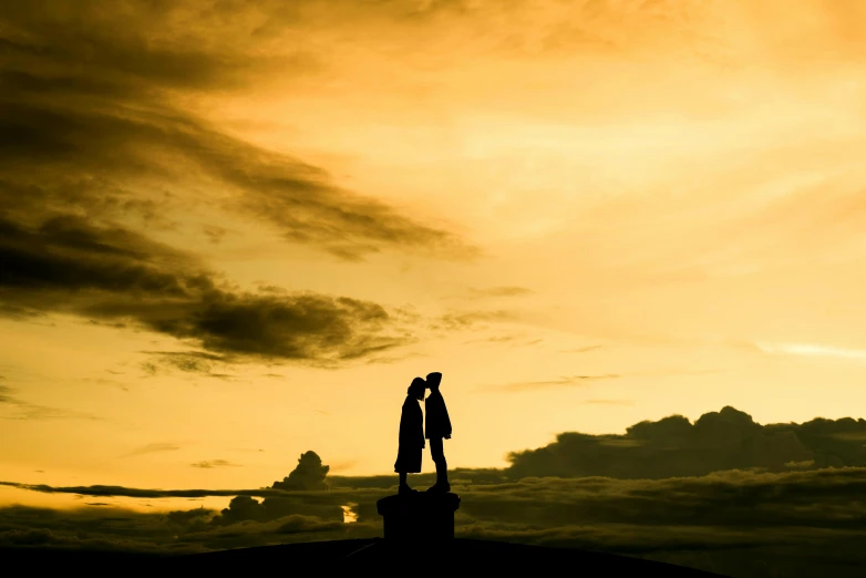 a couple of people standing on top of a hill, by Peter Churcher, pexels contest winner, romanticism, yellow sky, profile image, liquid gold, post processed denoised