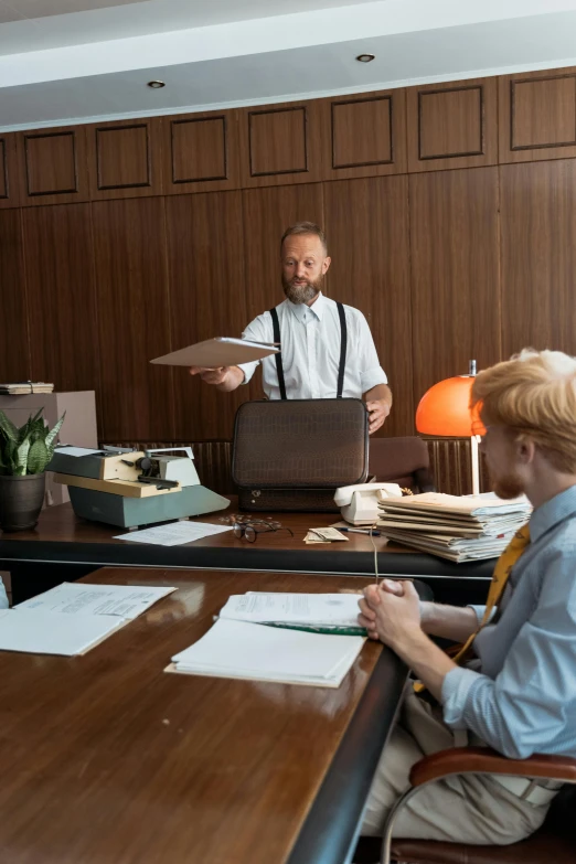 a group of people sitting around a wooden table, on desk, holding a briefcase, high-quality photo, thumbnail