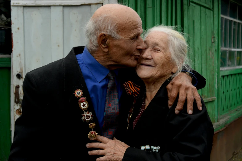 a couple of older people standing next to each other, by Boris Vladimirski, pexels contest winner, peasant boy and girl first kiss, ayanamikodon and irakli nadar, photograph credit: ap, a still of a happy