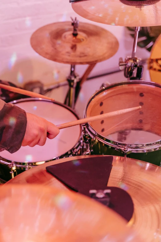 a close up of a person playing drums, profile image, a high angle shot, colour corrected, clubs