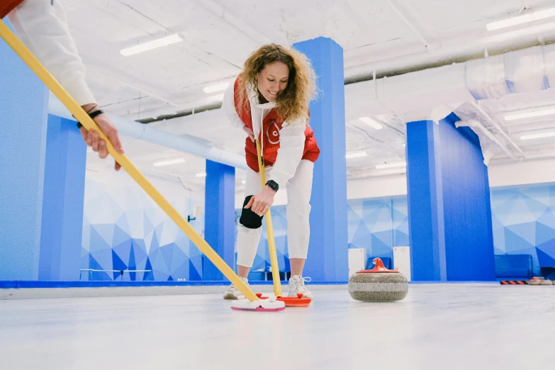 a couple of women playing a game of curling, by Julia Pishtar, pexels contest winner, process art, white, spacious, holding a giant flail, white cyc