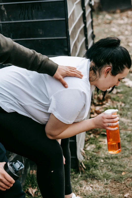 a couple of women standing next to each other, passed out, holding a bottle, hugging her knees, 2019 trending photo