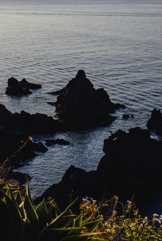 a large body of water sitting on top of a lush green hillside, an album cover, by Elsa Bleda, unsplash, dark rocks, taiwan, low quality photo, late summer evening