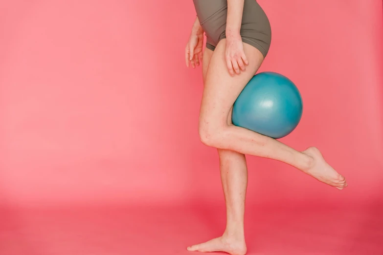 a woman standing on top of a blue ball, by Rachel Reckitt, dribble, thigh gap, pink, featured, turqouise