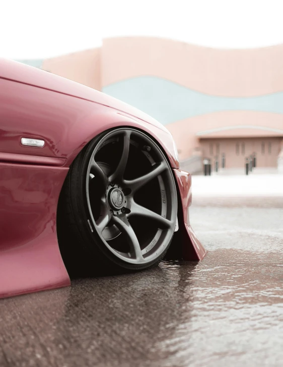 a pink sports car parked in a parking lot, by An Gyeon, unsplash contest winner, renaissance, black wheel rims, slick wet walls, profile image, taken in the 2000s