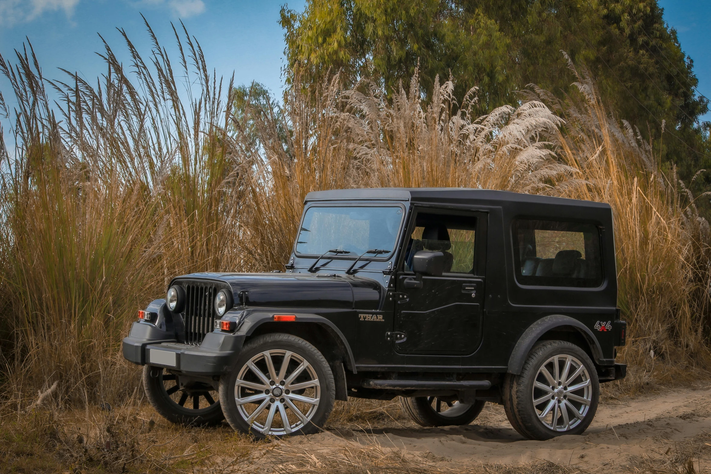 a black jeep parked on a dirt road, mahindra thar, portrait mode photo, super high resolution, zigor samaniego style