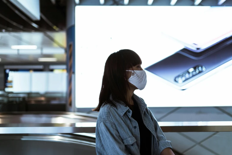 a woman wearing a face mask sitting on an escalator, trending on unsplash, hyperrealism, giant led screens, stood in a lab, hyperdetailed samsung store, avatar image