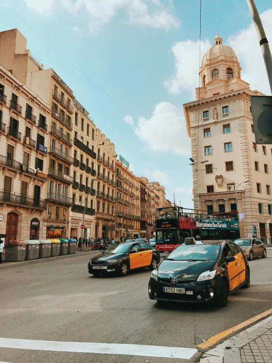 a street filled with lots of traffic next to tall buildings, a picture, spanish, 🚿🗝📝, 2 5 6 x 2 5 6 pixels, cars parked underneath