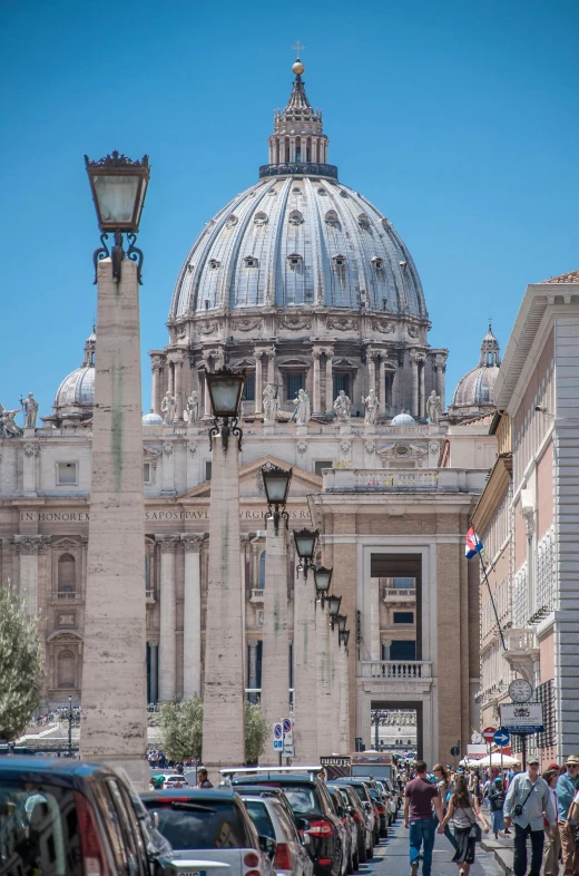 a group of people walking down a street in front of a building, a photo, inspired by Cagnaccio di San Pietro, neoclassicism, dome, huge support buttresses, seen from a distance, lamp posts
