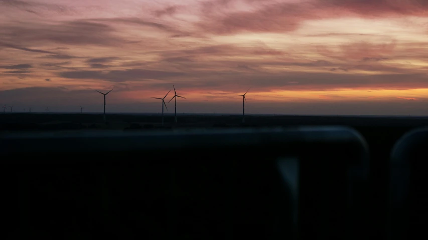 a sunset with wind turbines in the distance, by Jan Tengnagel, pexels contest winner, dark and moody, three views, electric breeze, panorama