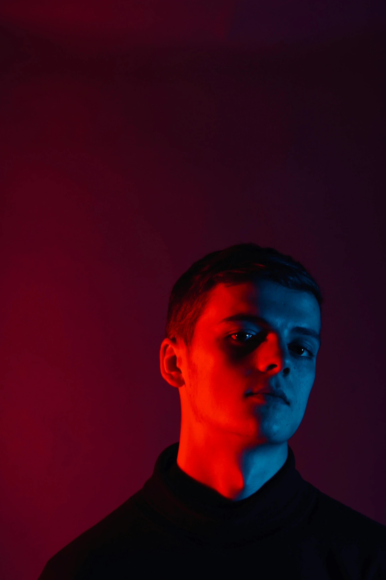 a man standing in front of a red light, an album cover, pexels contest winner, declan mckenna, high contrast studio lighting, yung lean, profile portrait