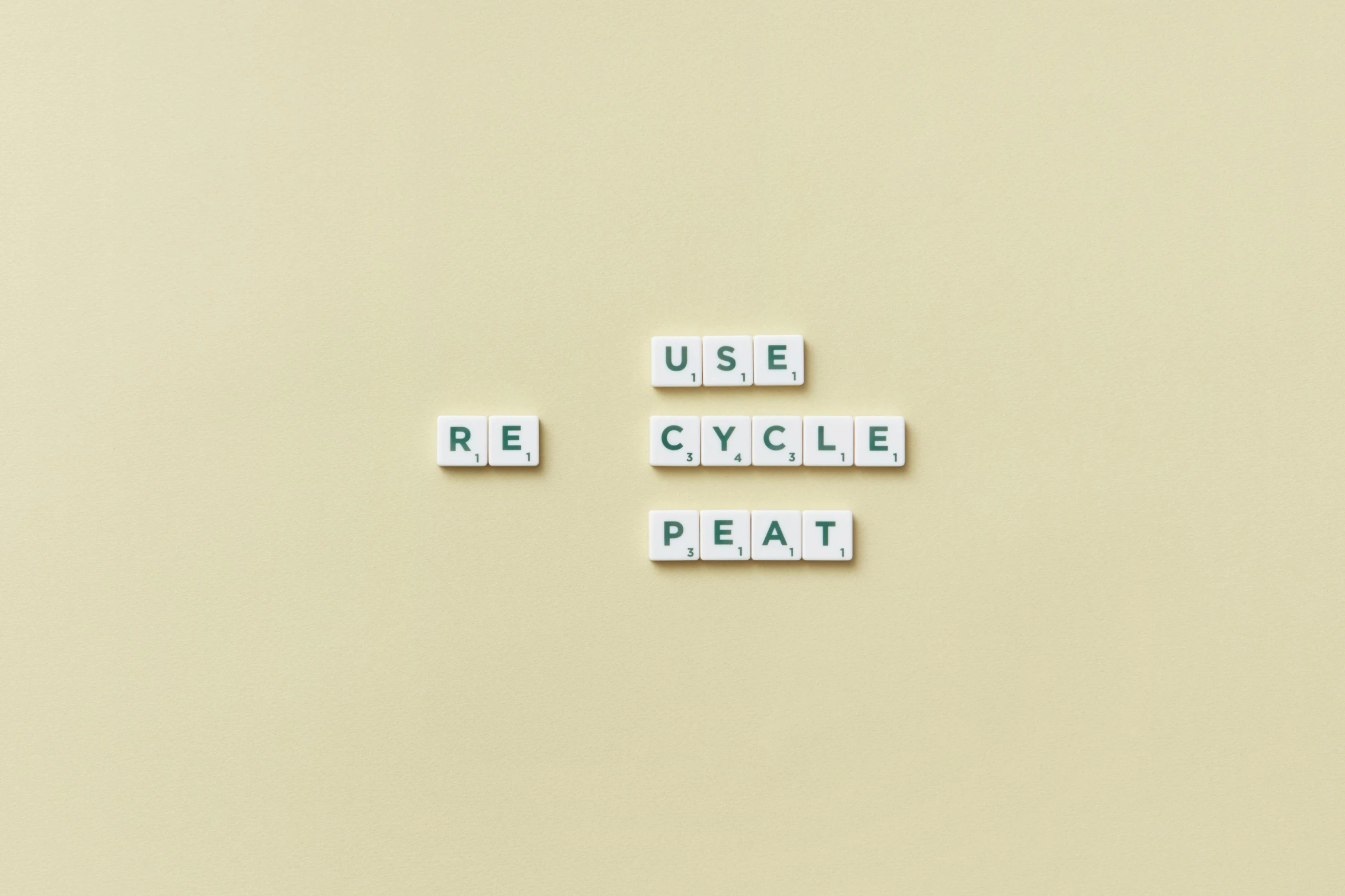 a couple of scrabbles sitting on top of a table, by Romain brook, unsplash, visual art, plastic waste, cycles, terminal text, on a pale background