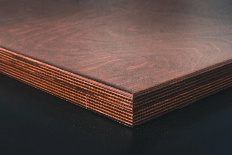 a close up of a piece of wood on a table, detailed product image, dark orange, round corners, birch