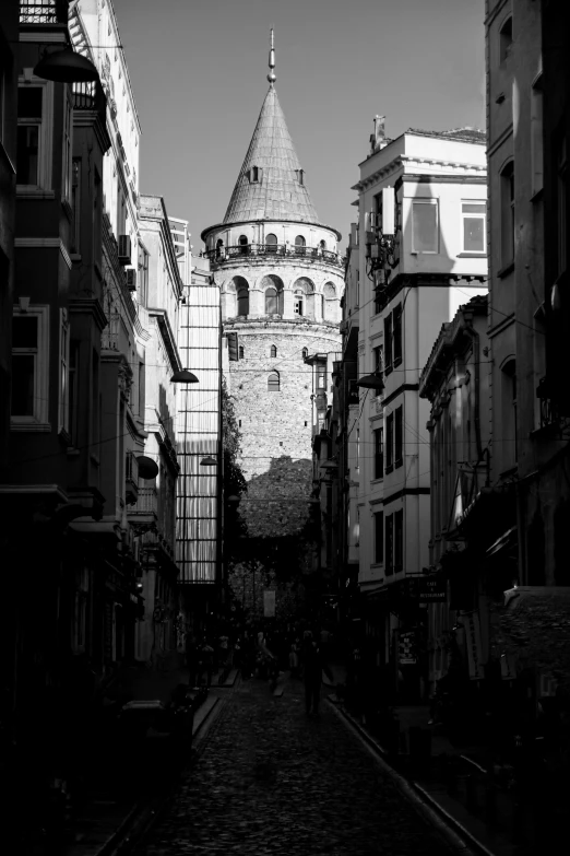 a black and white photo of a narrow street, a black and white photo, inspired by Kerembeyit, neoclassical tower with dome, the fall of constantinople, 256x256, visible from afar!!