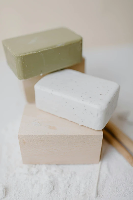 a couple of soap bars sitting on top of a table, inspired by Josef Block, clay material, recycled, thumbnail, white