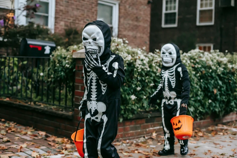 two children dressed up as skeletons walking down the street, pexels, 👰 🏇 ❌ 🍃, gif, high quality photo, boys