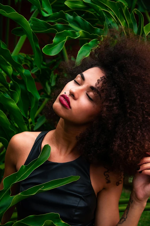 a woman with curly hair posing for a picture, by Sven Erixson, trending on pexels, lush jungle, fashion model face closed eyes, wild black hair, various posed