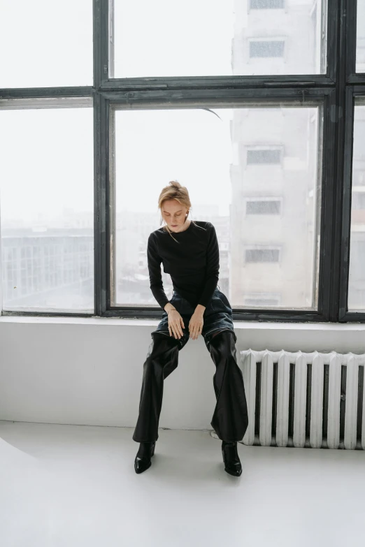 a woman sitting on top of a window sill, by Nina Hamnett, trending on unsplash, total black outfit, large pants, alexey gurylev, on a white table