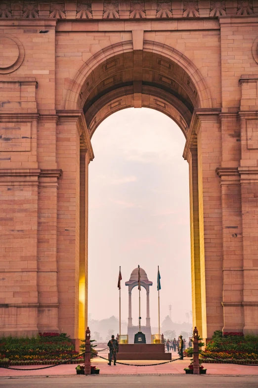 the entrance to india gate in new delhi, pexels contest winner, visual art, center frame medium shot, archs, flags, city morning