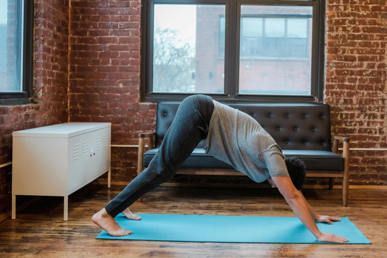 a person doing a yoga pose on a yoga mat, by Carey Morris, hurufiyya, 8 k -, next to window, 30 year old man :: athletic, canva