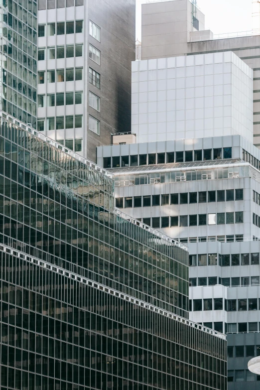 a city street filled with lots of tall buildings, by Daniel Seghers, unsplash, modernism, broken panes of glass, mies van der rohe, zoomed in, square lines