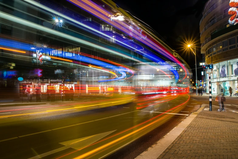 a blurry picture of a city street at night, a picture, by Konrad Witz, unsplash contest winner, london bus, high speed motion, bus station, blue and orange rim lights