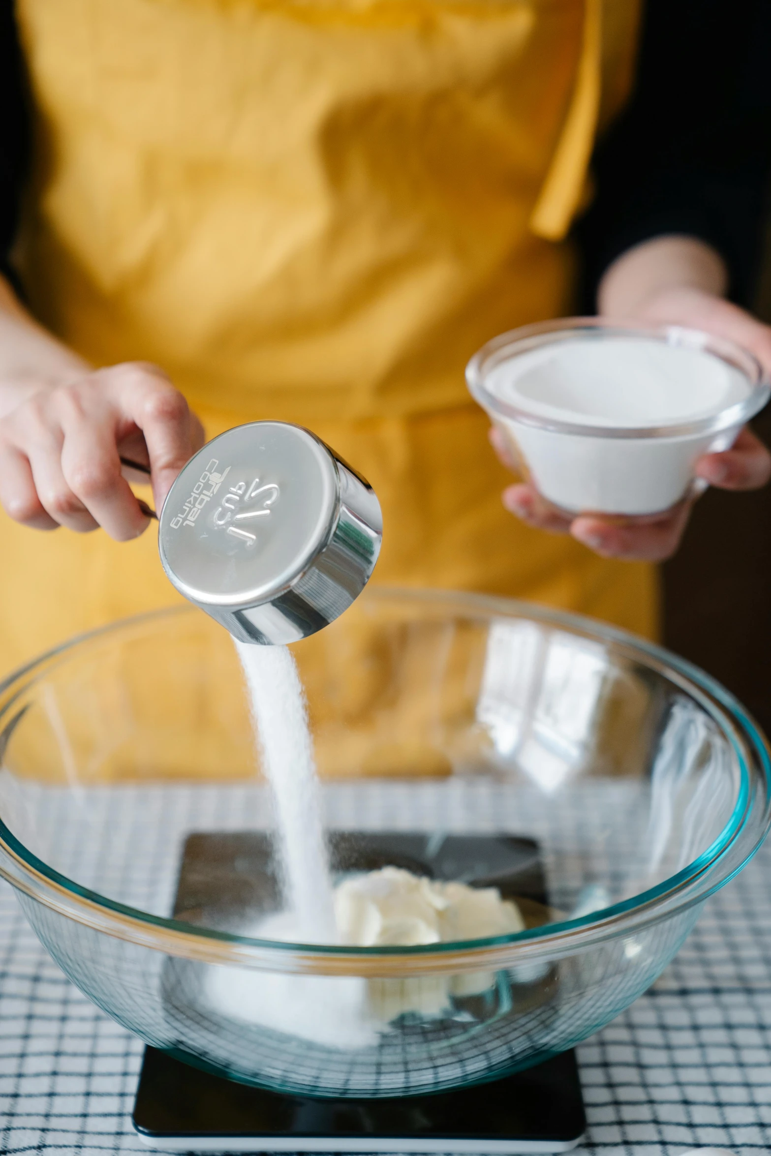 a person pouring milk into a glass bowl, detailed product image, kek, artisan, white salt