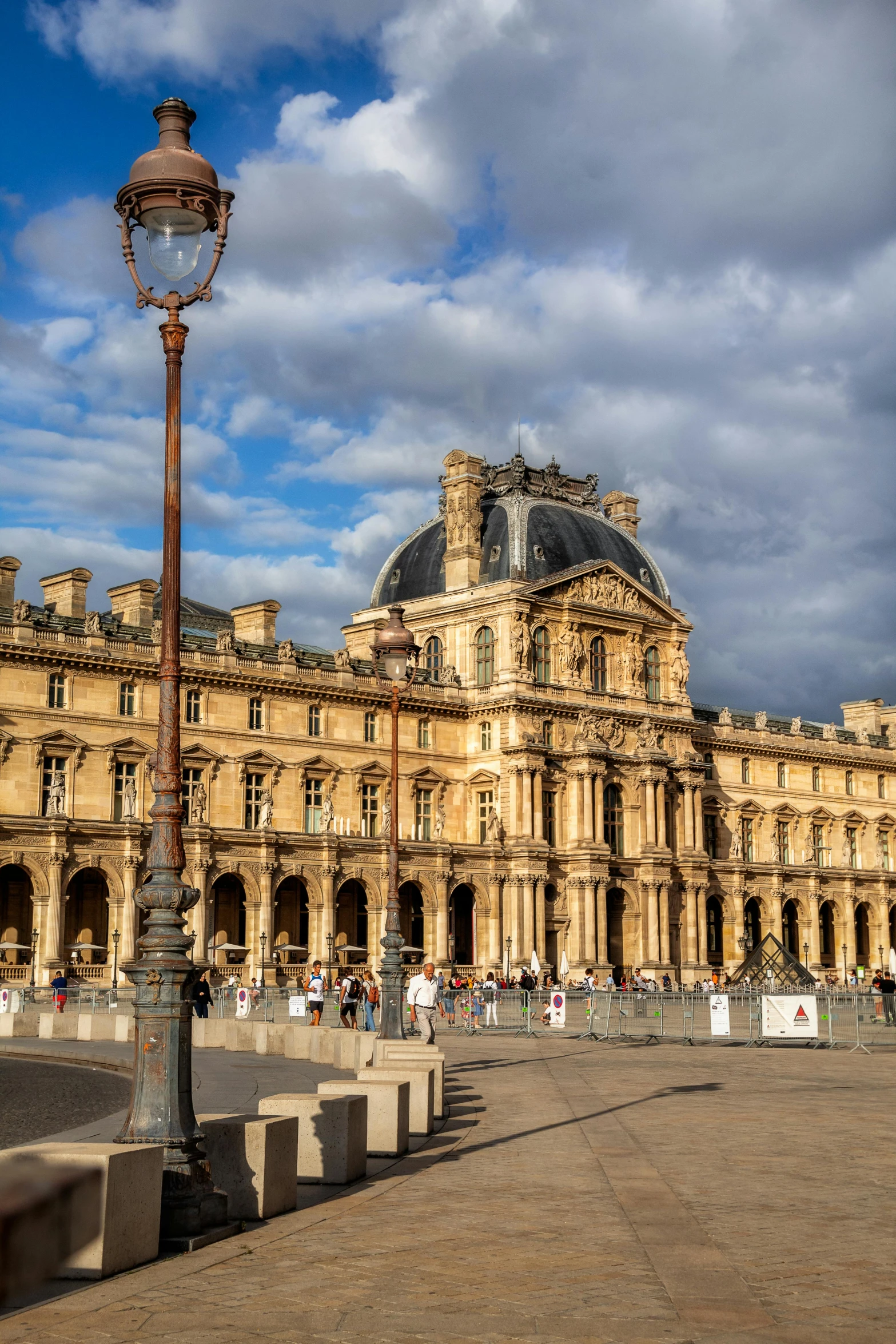 a street light in front of a large building, a photo, pexels contest winner, paris school, square, royal palace, a quaint, joan of arc