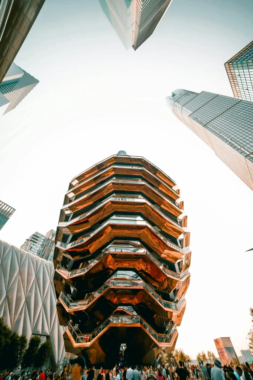 a group of people standing in front of a tall building, inspired by Zaha Hadid, unsplash contest winner, hexagonal shaped, rusty metal towers, view from ground level, new york buildings