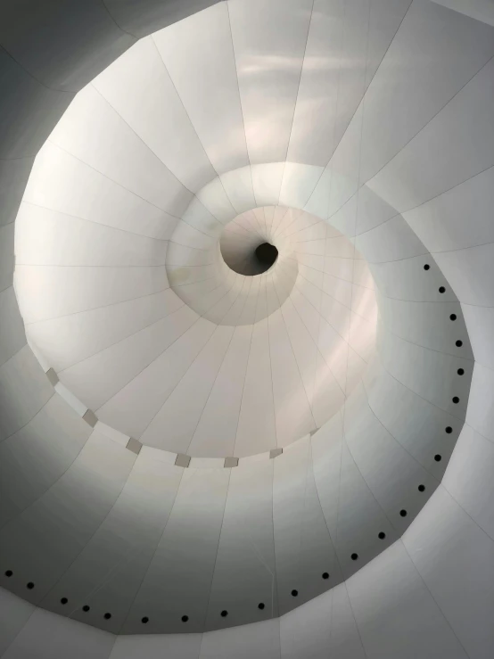 a view of the inside of a hot air balloon, an abstract sculpture, inspired by Anish Kapoor, unsplash contest winner, light and space, walking down a marble stairwell, white spiral horns, ignant, interior of a tent