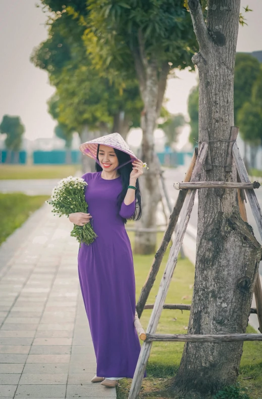 a woman in a purple dress standing next to a tree, inspired by Tan Ting-pho, pexels contest winner, wearing a cute hat, carrying flowers, 15081959 21121991 01012000 4k, in a city square