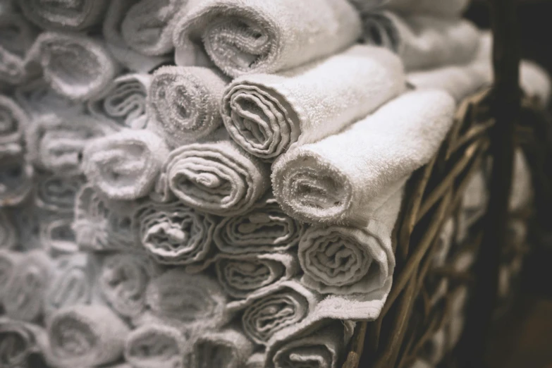 towels stacked on top of each other in a basket, by Daniel Gelon, unsplash, process art, silver，ivory, scrolls, grainy, many small details