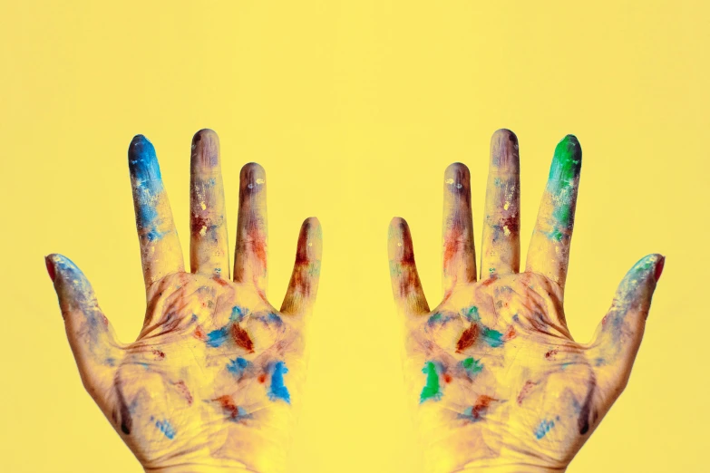 a close up of a person's hands with paint on them, an album cover, trending on pexels, yellow colours, multi colour, frank moth, 5 fingers
