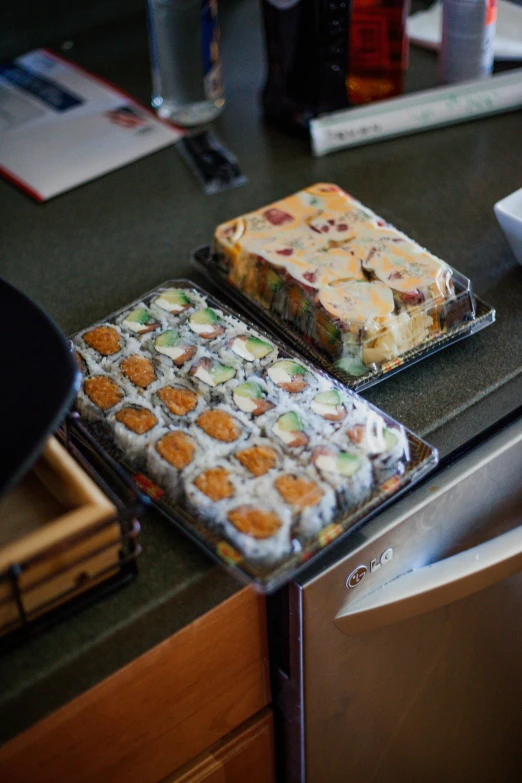 two trays of food sitting on top of a kitchen counter, inspired by Maki Haku, medium close shot, colorado, cakes, 6 pack