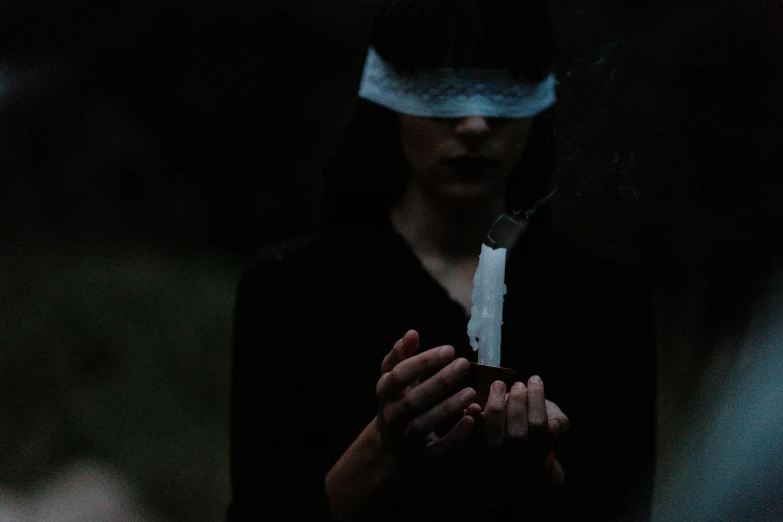 a close up of a person holding a knife, inspired by Elsa Bleda, surrealism, holding a candle, black blindfold, witch in the woods, instagram photo