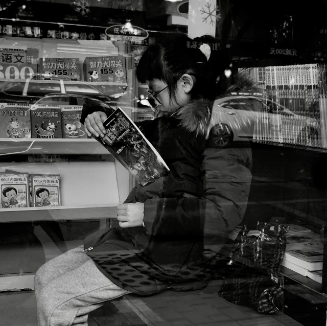 a woman sitting on a bench reading a book, a picture, inspired by Henri Cartier-Bresson, flickr, convenience store, transparent glass woman, inspired in hirohiko araki, highly reflective