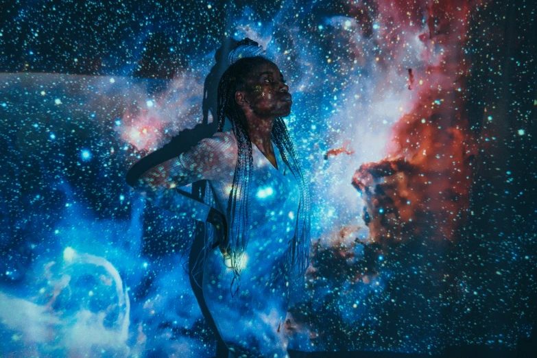 a man with dreadlocks standing in front of a galaxy, by Julia Pishtar, pexels contest winner, afrofuturism, photo of a black woman, projection mapping, painting by android jones, brandon woelfel