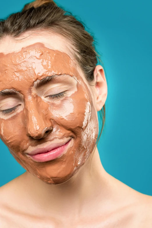 a woman with a mud mask on her face, by Julia Pishtar, cinnamon skin color, promo image, chocolate, skincare