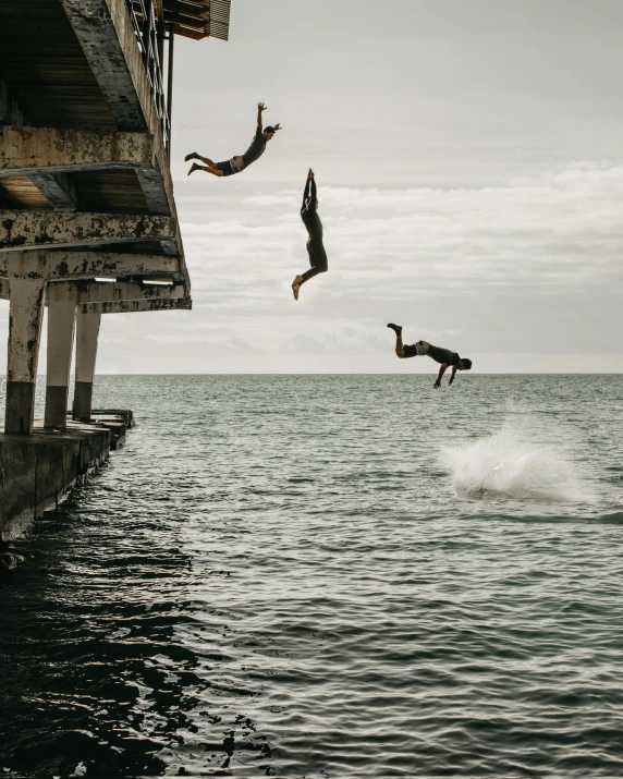 two people jumping off a pier into the ocean, unsplash contest winner, renaissance, diving suit, non-binary, on a hot australian day, ignant