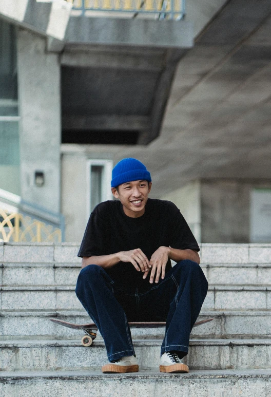 a man sitting on some steps with a skateboard, inspired by Reuben Tam, headshot profile picture, thawan duchanee, blue slide park, looking happy