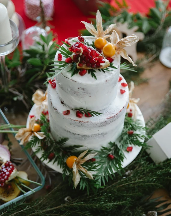 a wedding cake sitting on top of a wooden table, by Alice Mason, pexels contest winner, festive, herbs, fruit, thumbnail