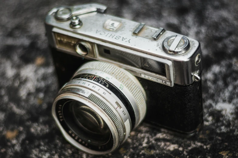 a close up of a camera on the ground, pexels contest winner, photorealism, very old photo, posing for a picture, well worn, agfa akurit