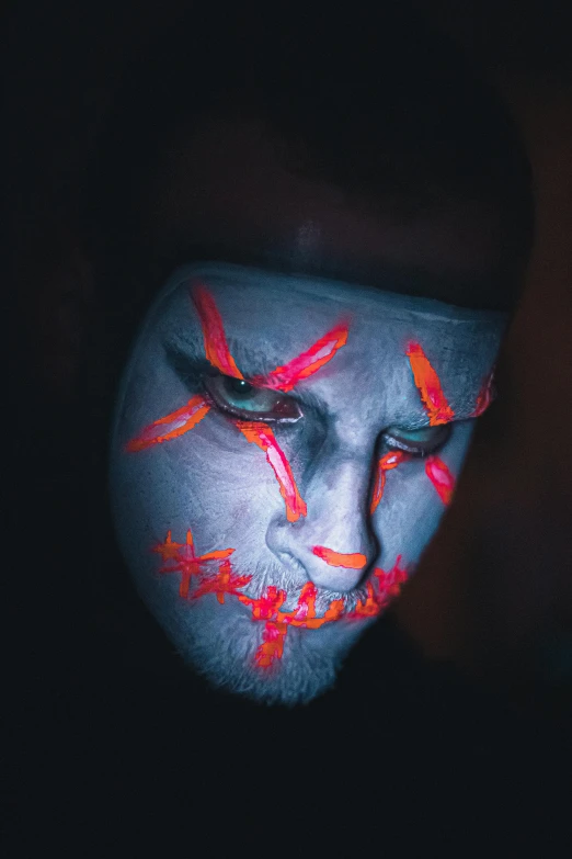 a man with neon paint on his face, an album cover, orange eyes, 2019 trending photo, classic kabuki, blacklight reactive