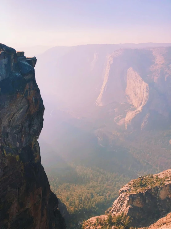 a man standing on top of a cliff overlooking a valley, by Ryan Pancoast, unsplash contest winner, yosemite valley, instagram story, zoomed out to show entire image, profile picture