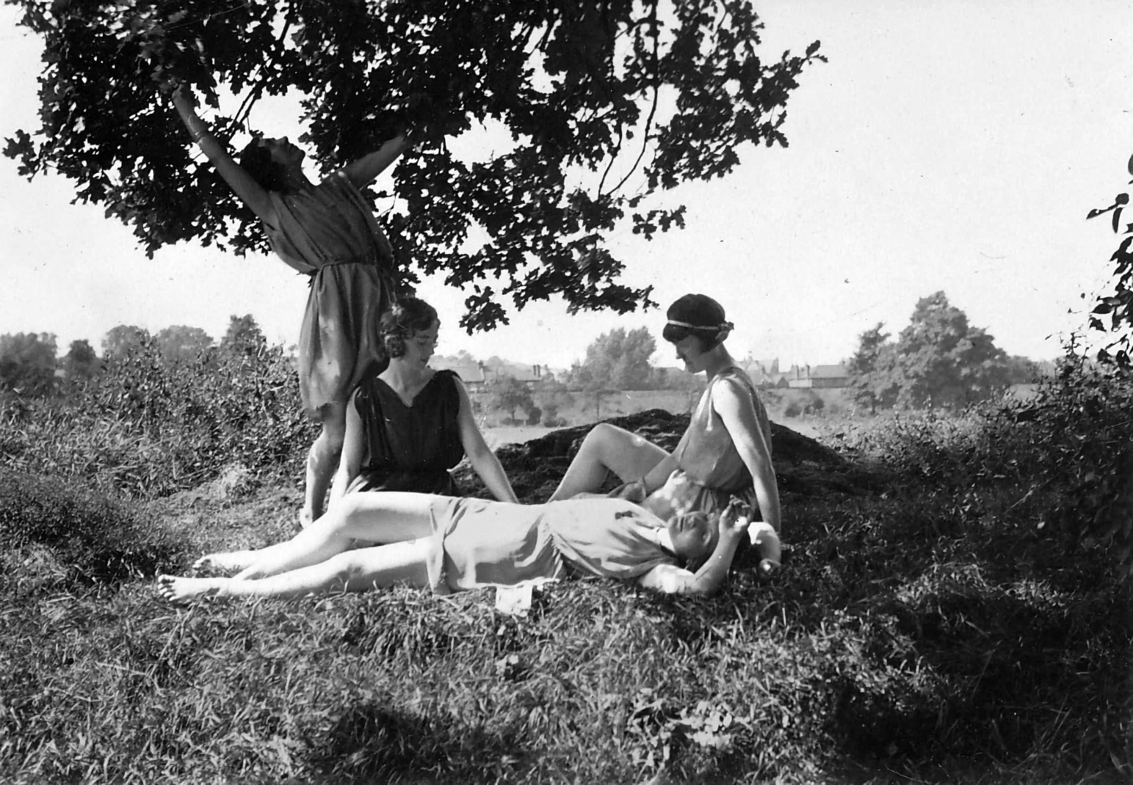 a couple of people that are laying in the grass, flickr, bauhaus, three women, sitting under a tree, 2 2 year old mary louise brooks, ap photo